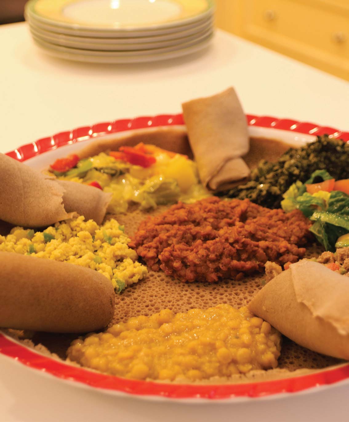 A traditional plating of injera with various vegetarian dishes prepared by Woldemedhin.