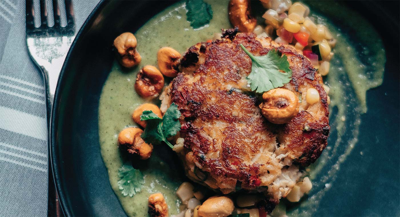 On the starter menu at The Keep, Chef Olson’s lump crab cake, served with a tomatillo-avocado sauce seasoned with cilantro, mint and charred jalapeño, with chow chow relish and fried hominy