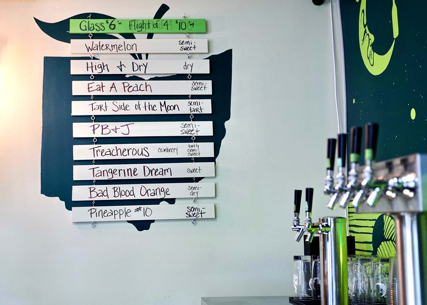 The menu board at Mad Moon shows a variety of cider flavors and styles.