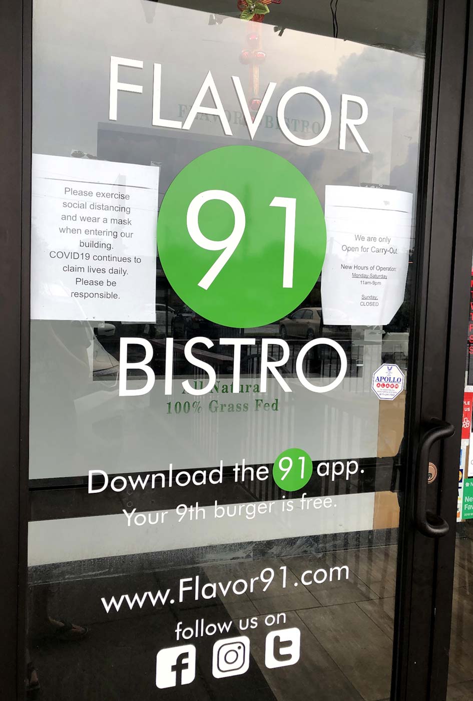 The door to Flavor 91 includes signage asking customers to maintain social distancing. Photo by Lauren Kurtz.
