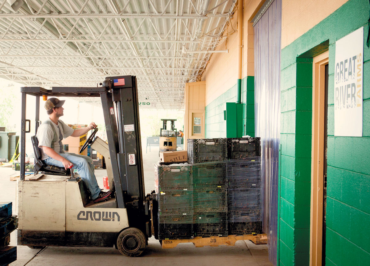 Adam Utley loading in pallets of food for distribution.