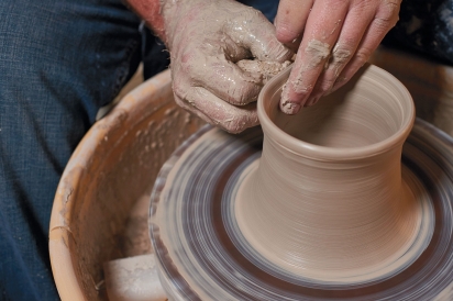 Lance Thompson of Simply Tangled Ceramics in Columbus throwing clay.