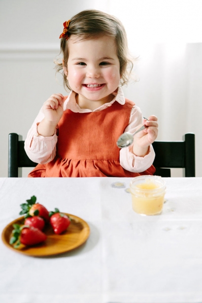 Bianca, just over 1½ years old, enjoys her applesauce and strawberries.